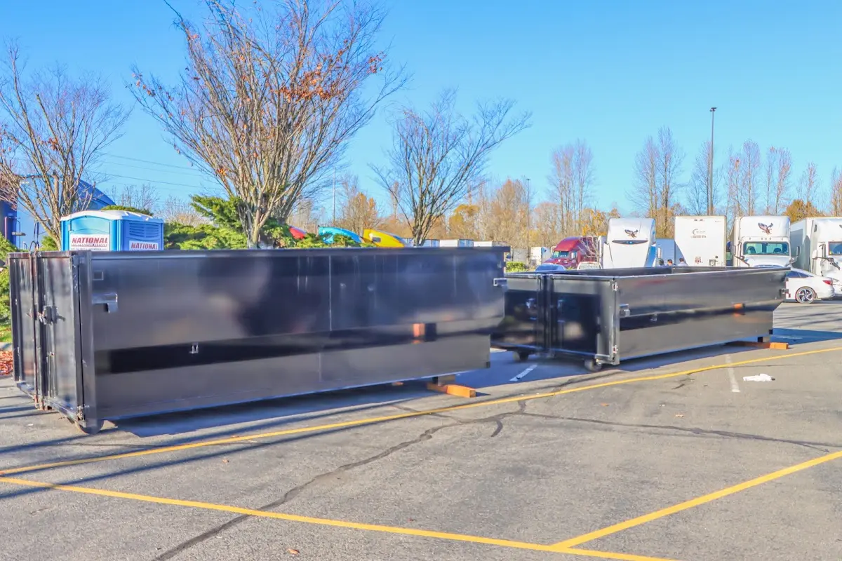 Professional dumpster rental service with roll-off container on residential driveway in Kernersville